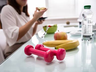 Woman eating healthy food in office